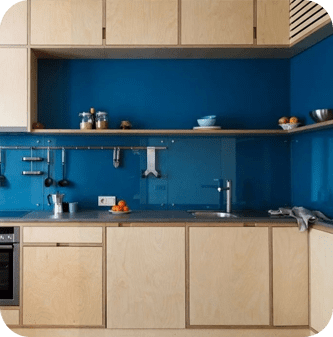 A kitchen with blue walls and wooden cabinets.